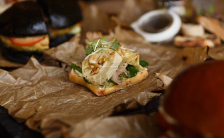 Foto de Snack de canapé gourmet con champiñones, nueces y micro greens servidos en papel pergamino para fiesta de vino - Imagen libre de derechos