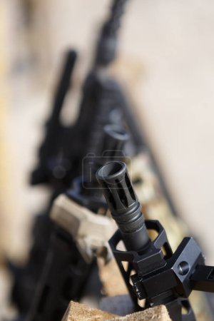 Photo for Automatic carbine gun barrel in close up. Modern American assault rifles on weapon stand - Royalty Free Image