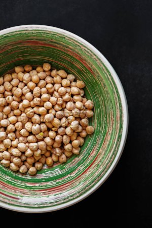 Photo for Bowl of dry chickpeas in flat lay. Raw chickpea beans prepared for cooking hummus or falafel - Royalty Free Image
