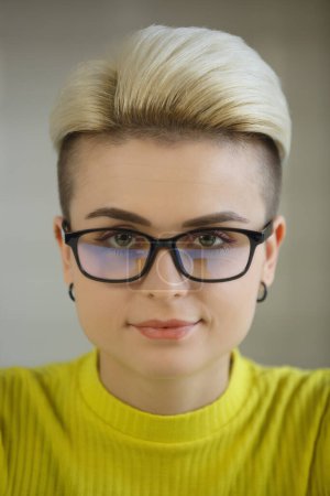 Photo for Portrait of beautiful tom boy woman in nerd glasses. Attractive short haired girl in eyeglasses looking in camera with smile - Royalty Free Image