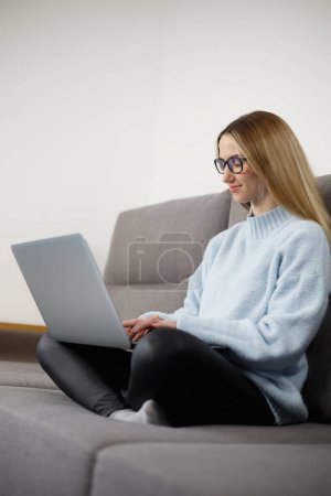 Photo for Person typing text on notebook computer. Programmer woman coding on laptop computer at home. - Royalty Free Image