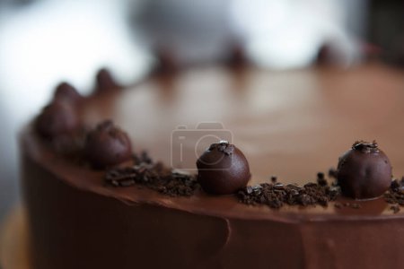 Photo for Cake with dark chocolate icing. Delicious pastry product in close up - Royalty Free Image