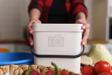 Photo for Responsible woman recycling organic food waste in a compost bin. Sustainable lifestyle and zero waste concept - Royalty Free Image