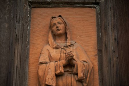 Photo for Wooden board with sculpture of young Madonna on a church exterior in Venezia. VENICE - 5 MAY,2019 - Royalty Free Image