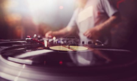 Photo for Club DJ playing music. Disc jockey playing hip hop music on a party in nightclub - Royalty Free Image