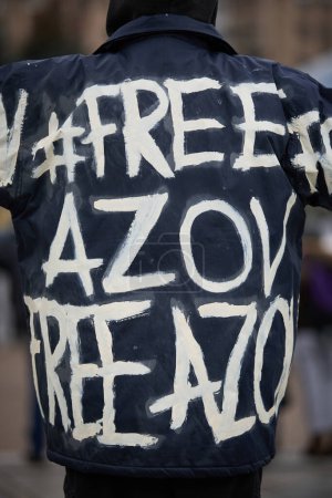 Photo for Person wearing a handmade coat with the writing "Free Azov". Kyiv - 18 February,2024 - Royalty Free Image