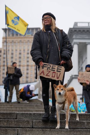 Photo for Ukrainian female show banner "Free Azov" on a rally at Maidan (Square of Independence) in Kyiv - 18 February,2024 - Royalty Free Image