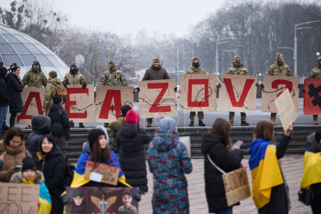Photo for Ukrainian soldiers hold banner "Where Is Azov?" on a rally dedicated to imprisoned defenders of Mariupol against russian invasion. Kyiv - 11 February,2024 - Royalty Free Image