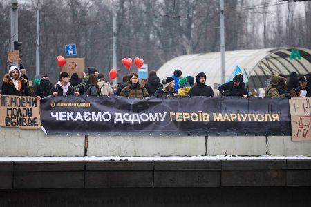 Photo for Activists hold  a banner "We Are Waiting For Heroes Of Mariupol Back Home" on a demonstration dedicated to captured defenders of Azovstal. Kyiv - 11 February,2024 - Royalty Free Image