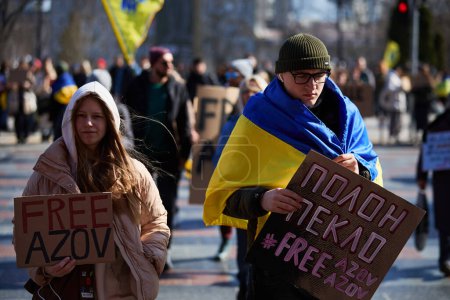 Photo for Ukrainian activists walk with banners "Free Azov" and "Captivity Is Hell" on a demonstration for release of captured soldiers. Kyiv - 10 March,2024 - Royalty Free Image