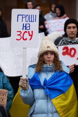 Photo for Ukrainian patriot holds a banner "Money On Army" on a public gathering in front of the city administration. Kyiv - 10 February,2024 - Royalty Free Image