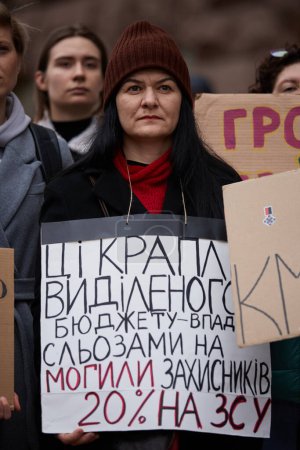 Photo for Ukrainian woman posing with a banner against corruption and for raise of military budget. Kyiv - 23 March,2024 - Royalty Free Image