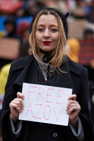 Photo for Ukrainian singer Vivienne Mort posing with a sign "Free Azov" at a public demonstration in Kyiv - 24 March,2024 - Royalty Free Image