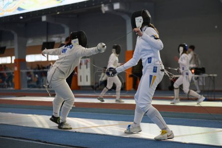 Photo for Young Ukrainian female fencers performing at the National Fencing Championship of Ukraine. Kyiv - 30 March,2024 - Royalty Free Image
