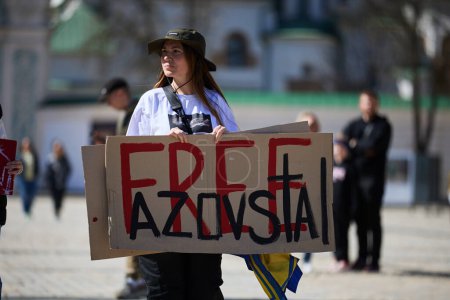 Photo for Ukrainian woman holds a banner "Free Azovstal" on a public protest. Kyiv - 7 April,2024 - Royalty Free Image