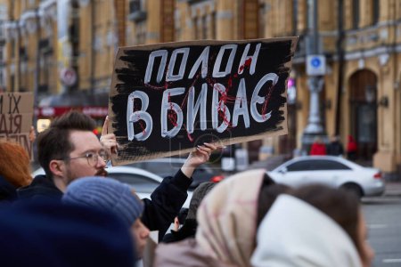 Photo for Ukrainian activist holds a banner "Captivity Kills" on a public demonstration. Kyiv - 4 February,2024 - Royalty Free Image