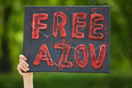 Photo for Person holds a banner "Free Azov" on a demonstration. Kyiv - 14 April,2024 - Royalty Free Image