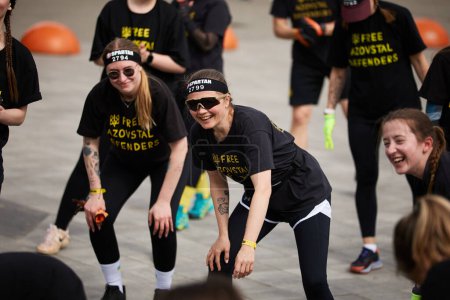 Cheerful Ukrainian women warming up before the run at the Spartan Race competition in Kyiv - 20 April,2024
