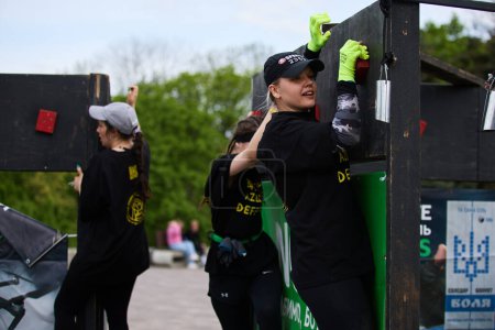 Téléchargez les photos : Les femmes escaladent le mur avec des prises dans une discipline "Z Wall" lors de la compétition Spartan Race à Kiev - 20 Avril, 2024 - en image libre de droit
