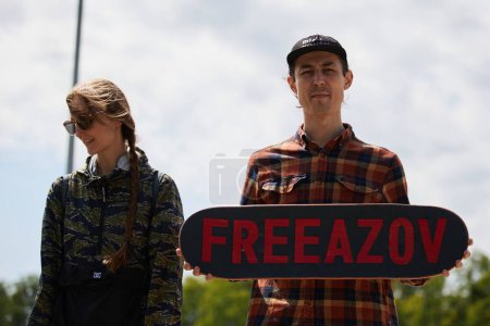 Photo for Ukrainian skaters posing with a skateboard with a writing "Free Azov" on a public event. Kyiv - 5 May,2024 - Royalty Free Image