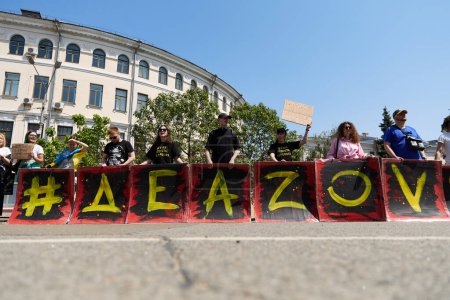 Photo for Activists posing with a banner "Free Azov" on a public demonstration in Ukraine. Kyiv - 19 May,2024 - Royalty Free Image