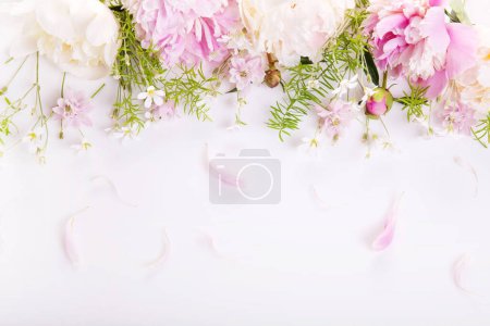 Wedding invitation or Mothers Day background, empty space with pink peony flowers, top view flat lay