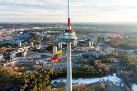 Photo for VILNIUS, LITHUANIA - FEBRUARY 16, 2022: Giant tricolor Lithuanian flag waving on Vilnius television tower on the celebration of Restoration of the State Day in Vilnius. - Royalty Free Image