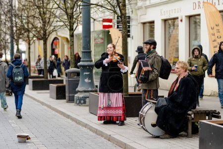 Photo for VILNIUS, LITHUANIA - MARCH 4, 2022: Folk singers and musicians playing music during Kaziuko muge or Kaziukas, traditional Easter market, crafts fair held every March on Old Town streets. - Royalty Free Image