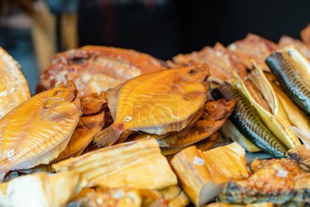 Photo for Selection of assorted home made smoked fish on a farmers market in Vilnius, Lithuania. Kaziukas, traditional spring fair in capital of Lithuania. - Royalty Free Image
