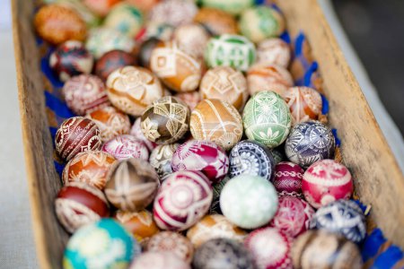 Photo for VILNIUS, LITHUANIA - MARCH 4, 2022: Colorful handmade wooden Easter eggs sold in annual traditional crafts fair in Vilnius, Lithuania - Royalty Free Image