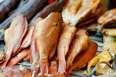 Photo for Selection of assorted home made smoked fish on a farmers market in Vilnius, Lithuania. Kaziukas, traditional spring fair in capital of Lithuania. - Royalty Free Image