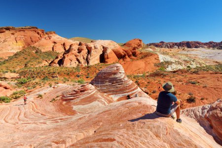 Photo for VALLEY OF FIRE, NEVADA, USA - APRIL 2016: Beautiful red and white stripes of the Fire Wave sandstone formation in Valley of Fire State Park, Nevada, USA. Exploring the American Southwest. - Royalty Free Image