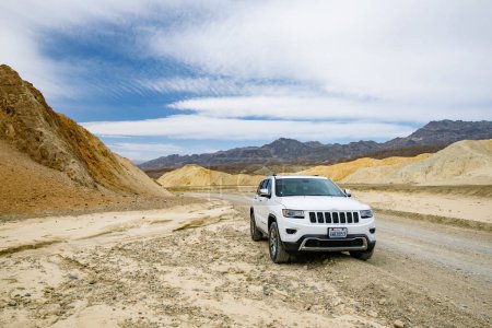Photo for DEATH VALLEY, CALIFORNIA, USA - APRIL 2016: Jeep Grand Cherokee on famous Twenty Mule Teams road in Death Valley National Park, California, USA. Exploring the American Southwest. - Royalty Free Image