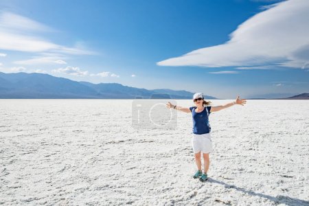 Photo for Young female hiker exploring salt crust in Badwater Basin, the lowest point in north America, Death Valley, California, USA. Exploring the American Southwest. - Royalty Free Image