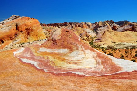 Photo for Beautiful red and white stripes of the Crazy Hill sandstone formation in Valley of Fire State Park, Nevada, USA. Exploring the American Southwest. - Royalty Free Image