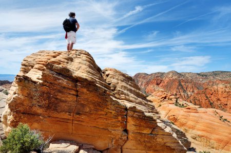 Photo for Young male hiker admiring the scenic view of marvelous red and white sandstone formations of Yant Flat in Utah, USA. Exploring the American Southwest. - Royalty Free Image