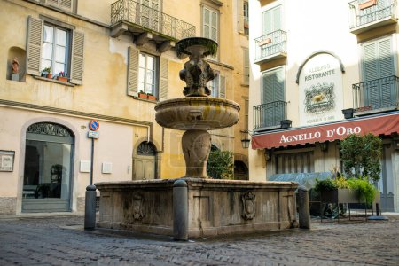 Photo for BERGAMO, ITALY - APRIL 2022: Fontana Del Gombito fountain in Bergamo city northeast of Milan. Scenic views of Citta Alta, town's upper district, encircled by Venetian walls. Bergamo, Lombardy, Italy. - Royalty Free Image