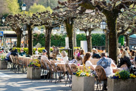 Photo for BELAGGIO, ITALY - APRIL 2022: Tourists and locals spending sunny spring day in Belaggio, a town on the shore of Lake Como. Charming location with typical Italian atmosphere. Belaggio, Lombardy, Italy. - Royalty Free Image