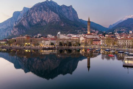 Stunning aerial cityscape of Lecco town on spring evening. Picturesque waterfront of Lecco town located between famous Lake Como and scenic Bergamo Alps mountains. Vacation destination in Italy.