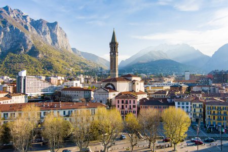 Photo for Sunny aerial cityscape of Lecco town on spring morning. Picturesque waterfront of Lecco town located between famous Lake Como and scenic Bergamo Alps mountains. Vacation destination in Italy. - Royalty Free Image