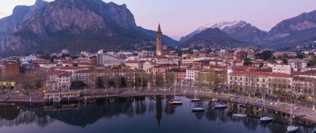 Photo for Stunning aerial cityscape of Lecco town on spring evening. Picturesque waterfront of Lecco town located between famous Lake Como and scenic Bergamo Alps mountains. Vacation destination in Italy. - Royalty Free Image