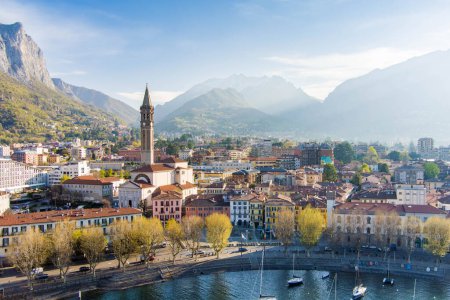 Photo for Sunny aerial cityscape of Lecco town on spring morning. Picturesque waterfront of Lecco town located between famous Lake Como and scenic Bergamo Alps mountains. Vacation destination in Italy. - Royalty Free Image