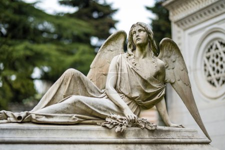 Photo for Impressive sculptures on the tombs and monuments of Cimitero Monumentale di Milano or Monumental Cemetery of Milan, the burial place of the most remarkable Italians. Milan, Italy. - Royalty Free Image