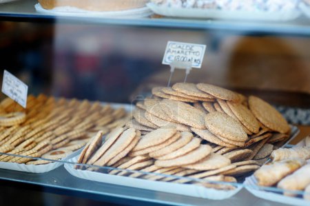 Téléchargez les photos : Biscuits Amaretto sur une vitrine. Bonbons, gâteaux et biscuits variés exposés dans un petit magasin de desserts à Pitigliano, Italie - en image libre de droit