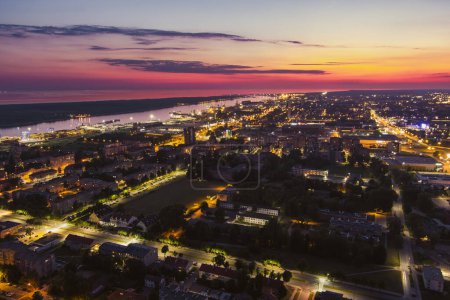 Photo for Scenic aerial view of the Old town of Klaipeda, Lithuania in purple evening light. Klaipeda city port area and it's surroundings on summer night. - Royalty Free Image