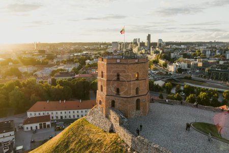 Photo for Aerial view of Gediminas Tower, the remaining part of the Upper Castle in Vilnius. Sunset landscape of UNESCO-inscribed Old Town of Vilnius, the heartland of the city, Lithuania. - Royalty Free Image