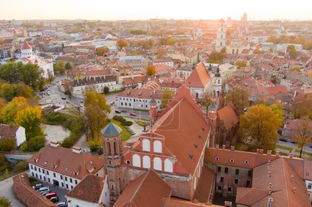 Photo for Aerial view of St. Anne Church and neighbouring Bernardine Church, one of the most beautiful and probably the most famous buildings in Vilnius. Beautiful autumn day in the capital of Lithuania. - Royalty Free Image