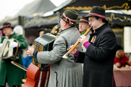 Téléchargez les photos : VILNIUS, LITUANIE - 4 MARS 2023 : Musiciens jouant sur Kaziuko muge ou Kaziukas, marché traditionnel de Pâques, foire artisanale annuelle tenue chaque année en mars dans les rues de la vieille ville. - en image libre de droit