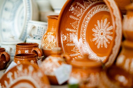 Photo for Ceramic dishes, tableware and jugs sold on Easter market in Vilnius. Lithuanian capital's annual traditional crafts fair is held every March on Old Town streets. - Royalty Free Image