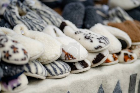 Photo for Warm sheep wool slippers sold on Easter market in Vilnius. Annual spring fair hold in March on the streets of capital of Lithuania. - Royalty Free Image